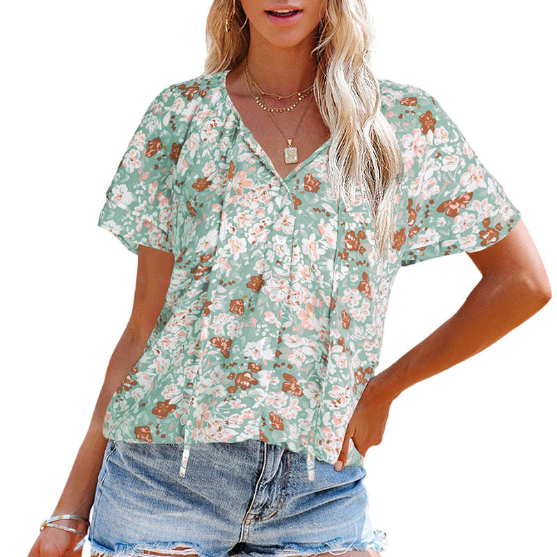 Women's airy blouse with floral pattern and decorative button details, size