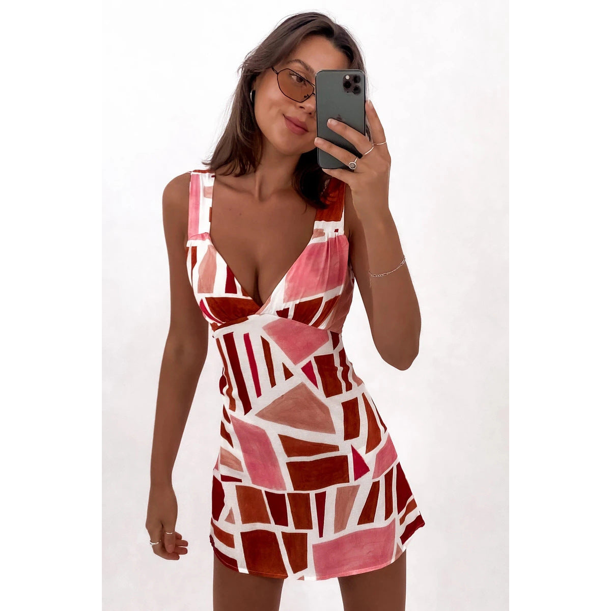 Women's figure-hugging mini dress with striking geometric design and deep V-neck, size [size]