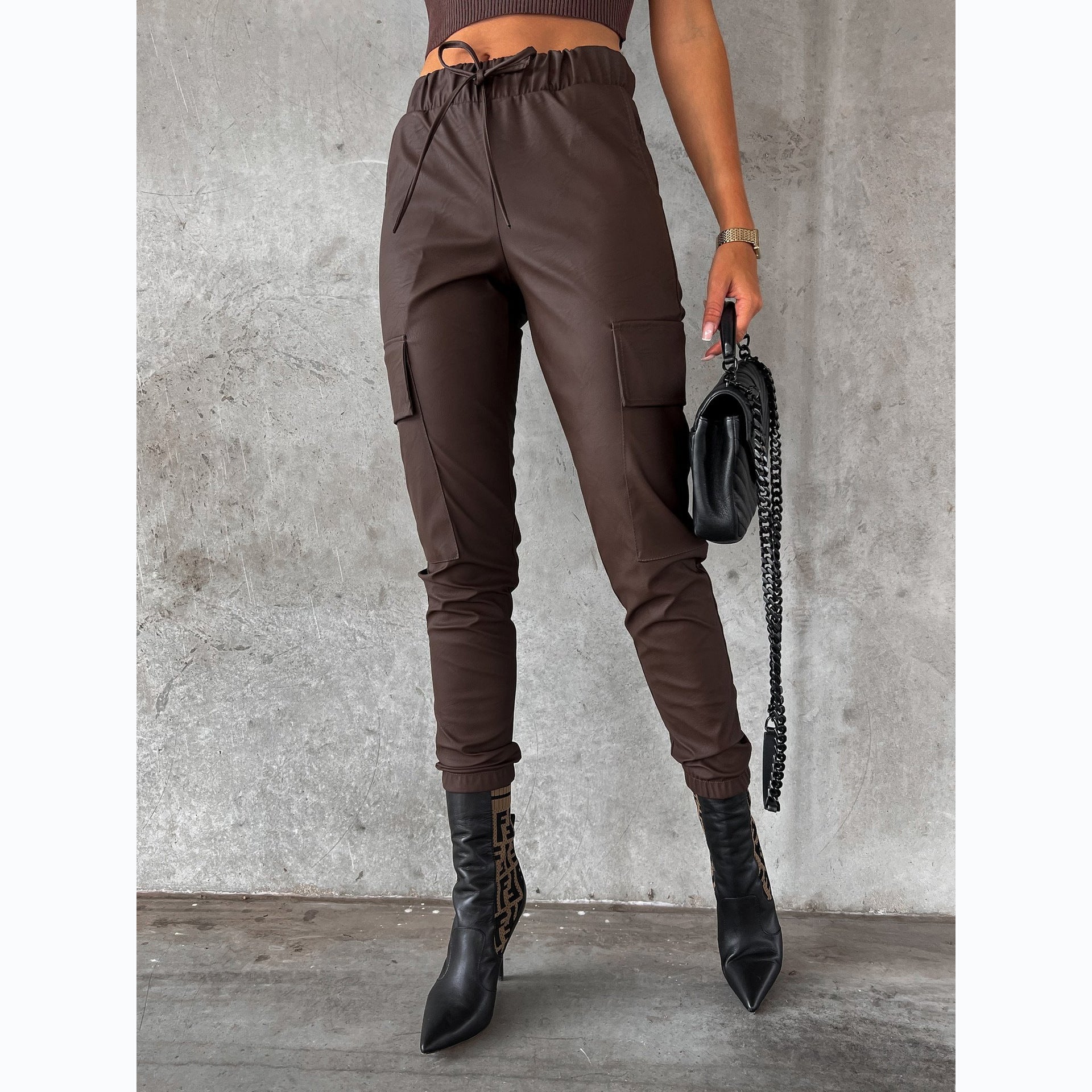 Women's faux leather jogging pants with practical pockets and elastic waistband, size