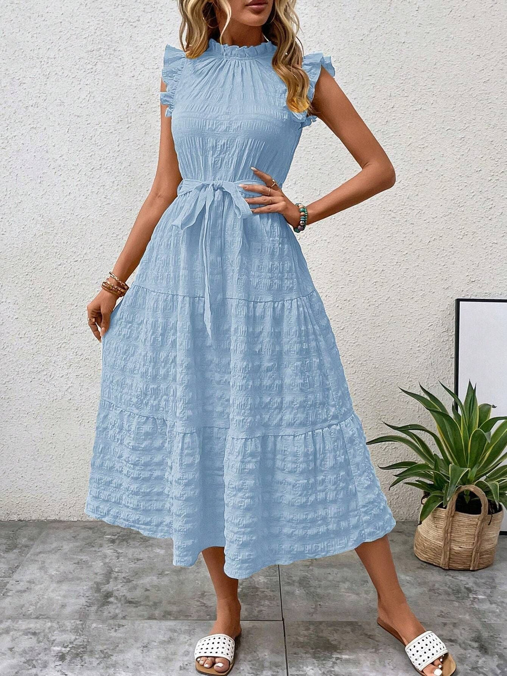 Women's wrap dress with ruffle details and a tailored hem, size