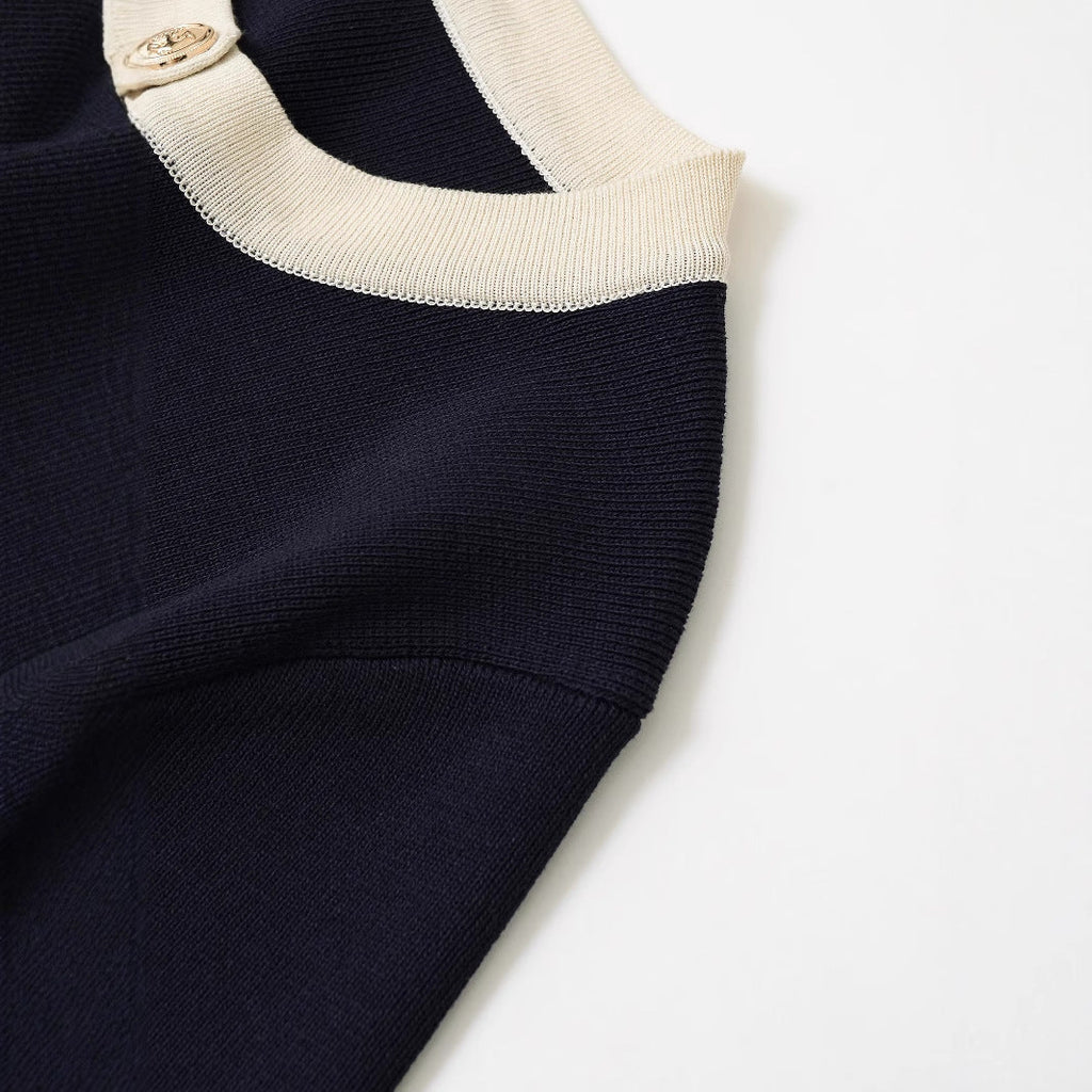 Women's short-sleeved knit top with decorative buttons and modern design, size S