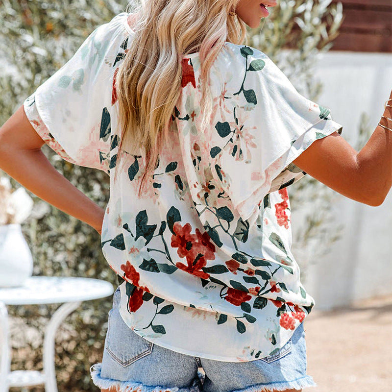 Women's airy blouse with floral pattern and decorative button details, size