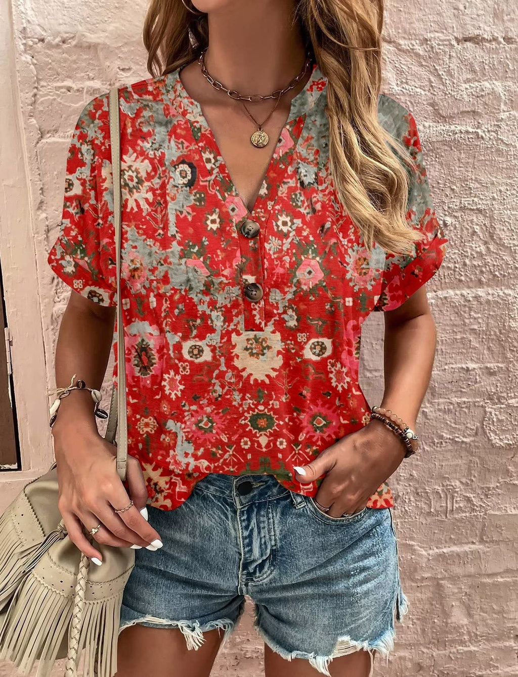 Women's casual short-sleeved blouse with a playful paisley pattern and modern button details, size S