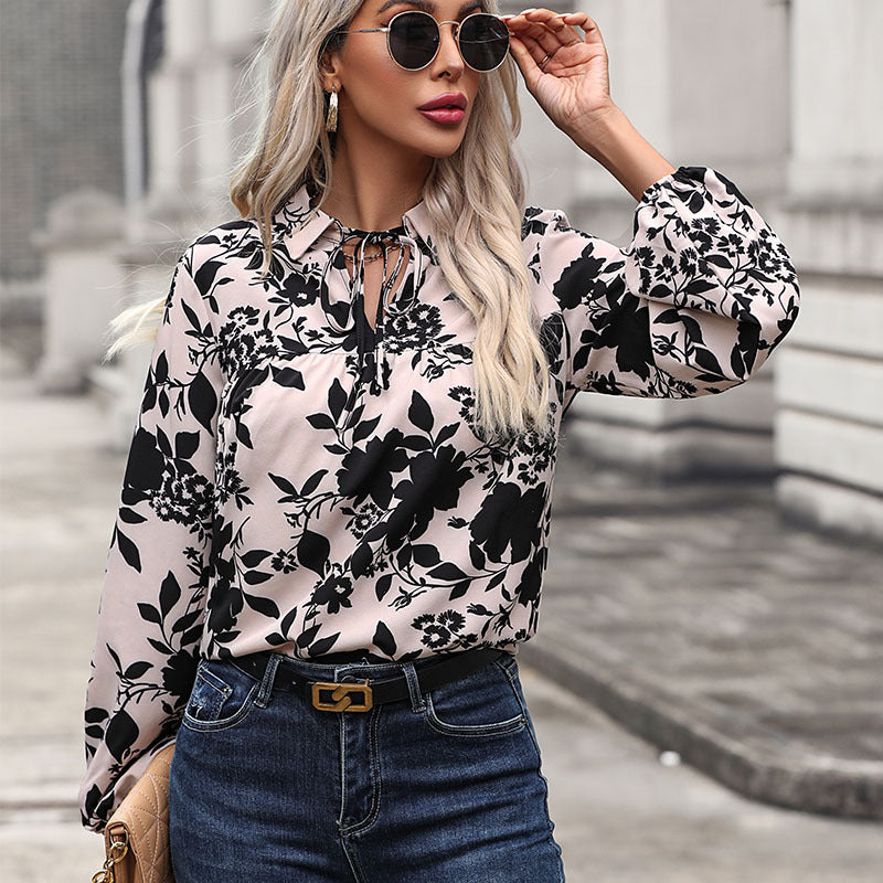 Women's blouse with floral design and decorative lacing detail, size