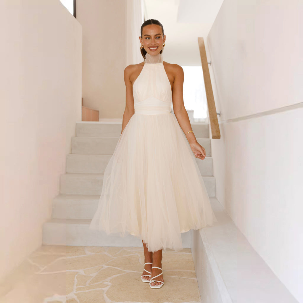 Women's elegant wedding dress with flowing tulle skirt and halter neck design, size S