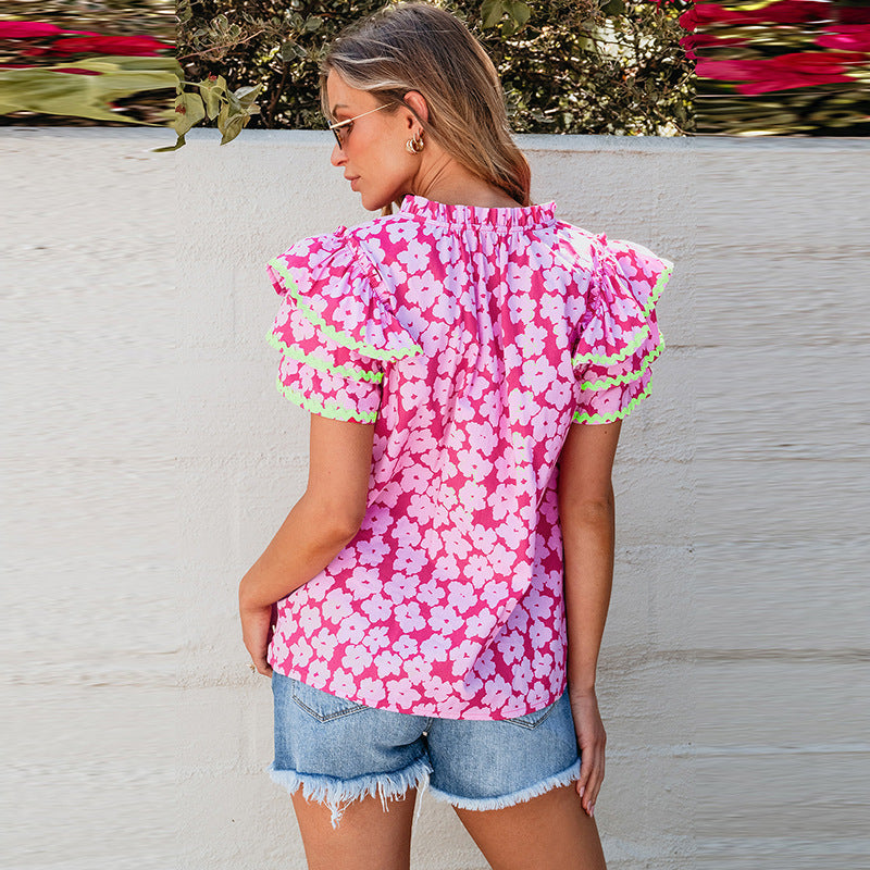 Women's top with striking floral pattern and ruffles, size