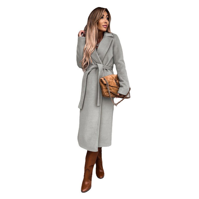 Women's elegant trench coat with tie belt and textured material, size S