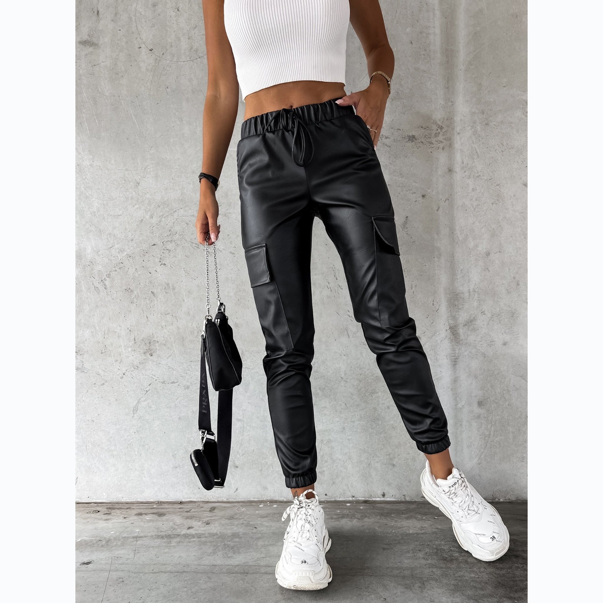 Women's faux leather jogging pants with practical pockets and elastic waistband, size