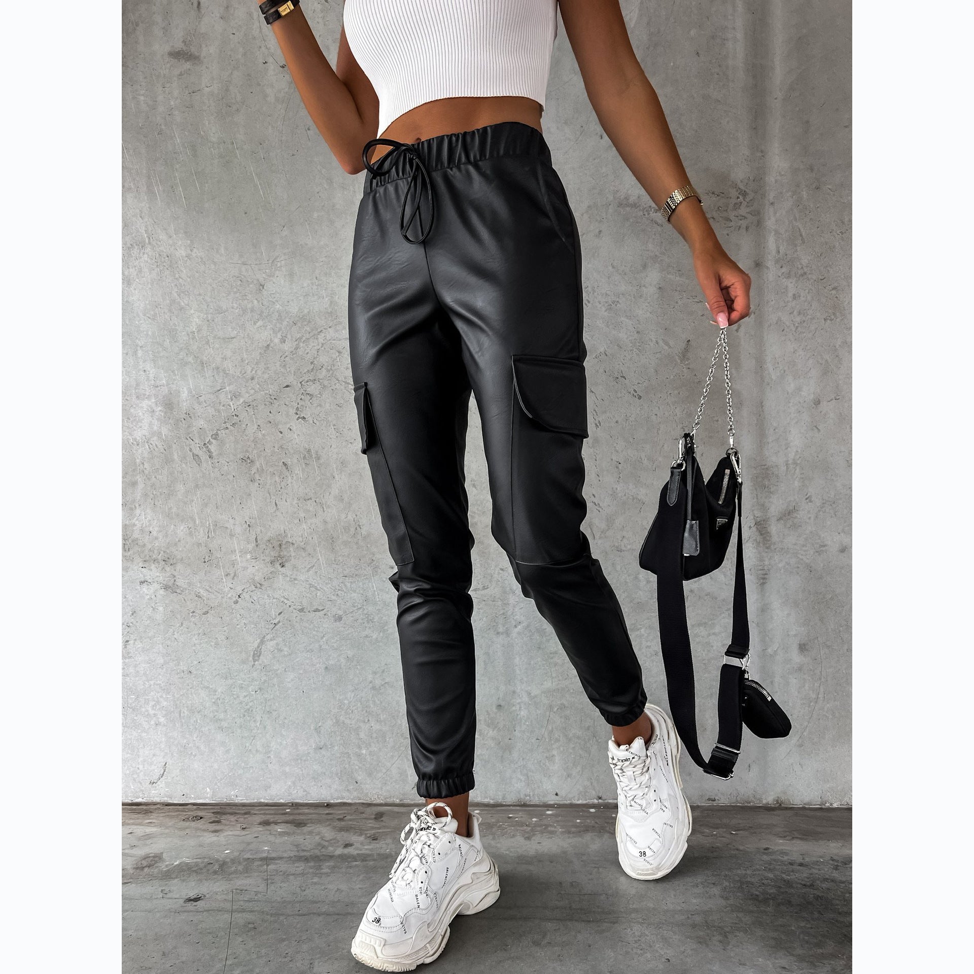 Women's faux leather jogging pants with practical pockets and elastic waistband, size