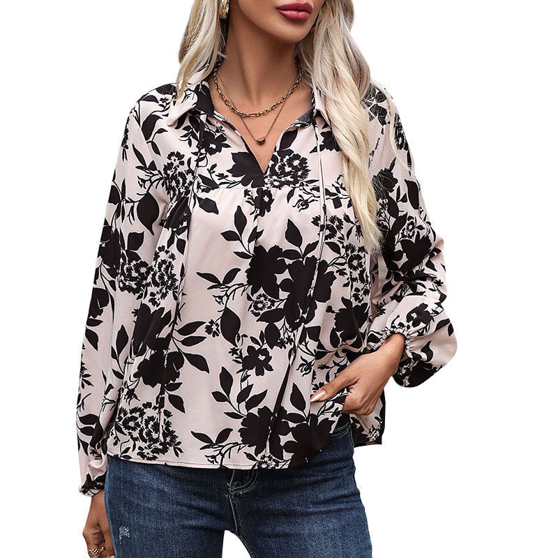 Women's blouse with floral design and decorative lacing detail, size