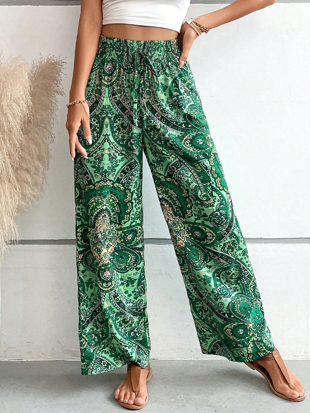 Women's wide-leg palazzo trousers with elasticated waistband and elegant paisley pattern, size S