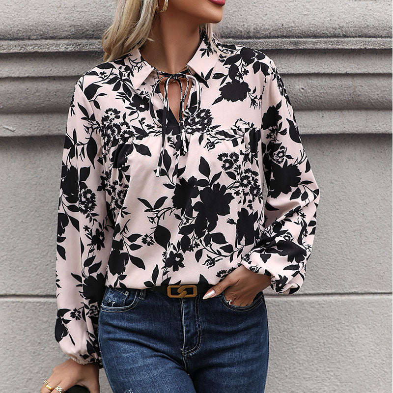 Women's blouse with elegant ruffle details and playful floral pattern, size