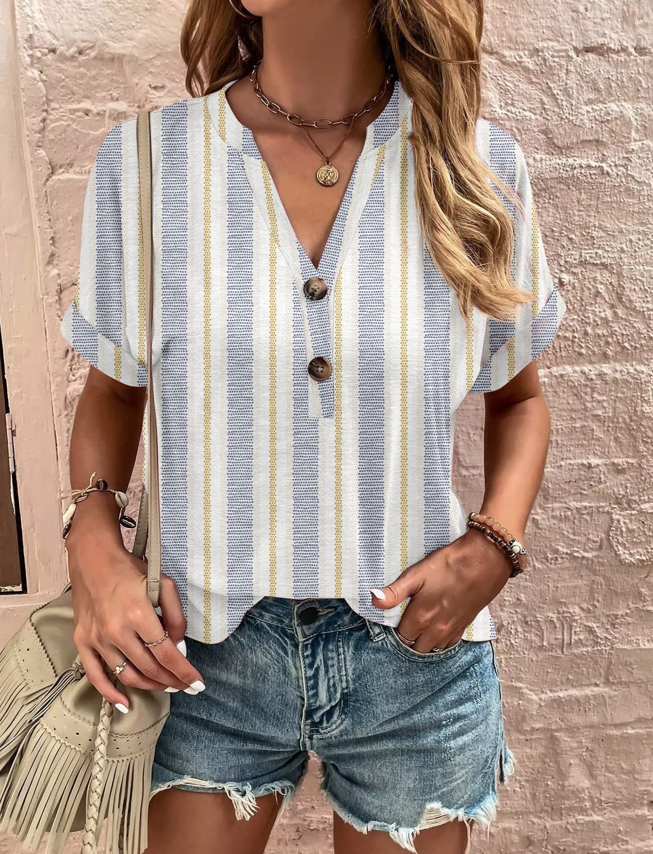 Women's casual short-sleeved blouse with a playful paisley pattern and modern button details, size S