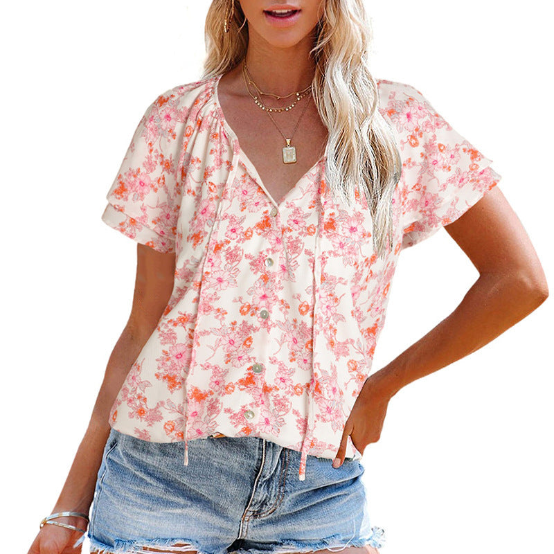 Women's airy blouse with floral pattern and decorative button details, size