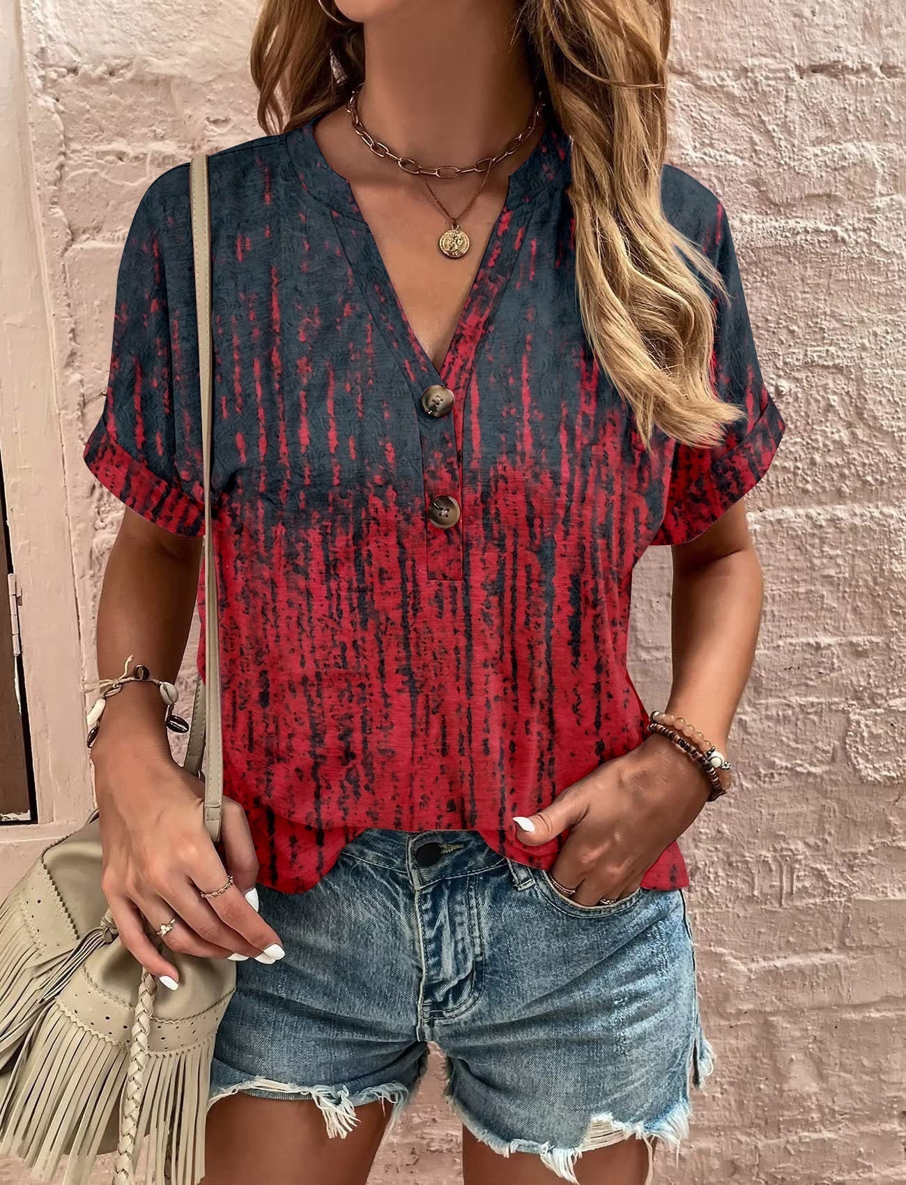 Women's casual short-sleeved blouse with a playful paisley pattern and modern button details, size S