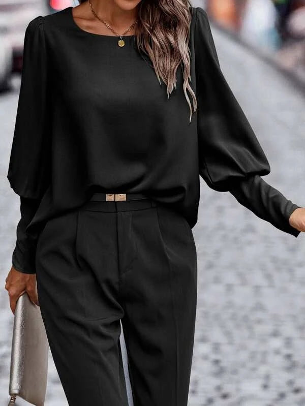 Women's blouse with elegant puff sleeves and flowing fabric, size S