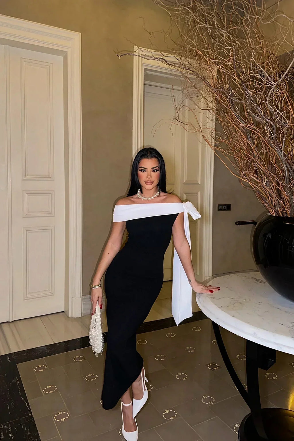 Valenzora | Elegant off-shoulder midi dress in black with white bow detail